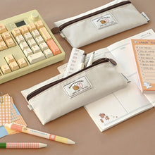 Load image into Gallery viewer, Monolike Happy and Lucky Flat Pencil Case, Ivory - Slim Water-Resistant Nylon Pen Pouch, Aesthetic Pastel Stationery Organizer for Office
